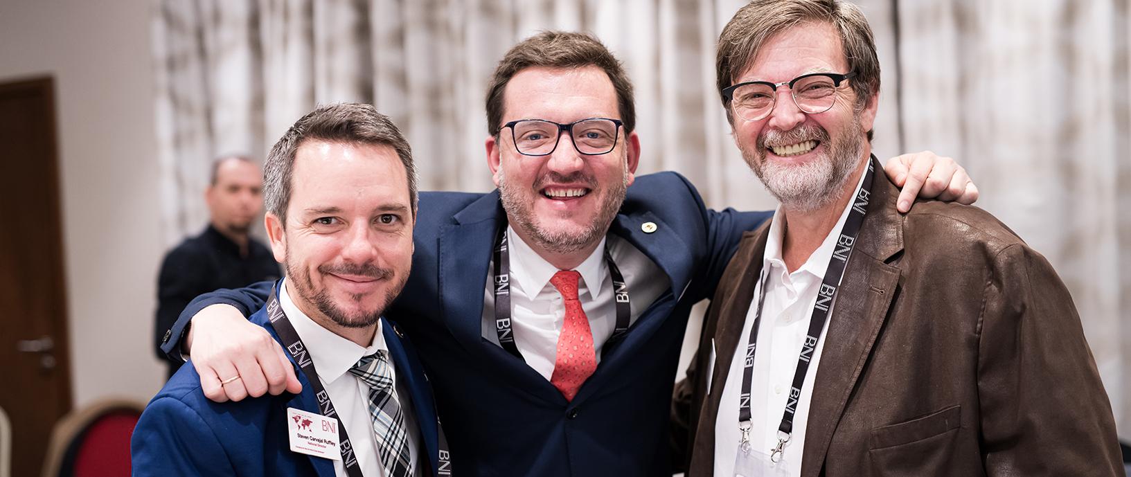 Three happy BNI Members arm in arm at the U.S. National Conference